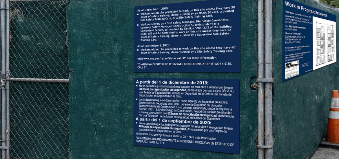 NYC Site Safety Training (SST) signs installed on a green construction fence at an active job site, informing workers of required safety training hours and site safety rules