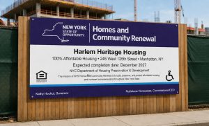 HCR project sign installed on construction site fence for affordable housing development in NYC